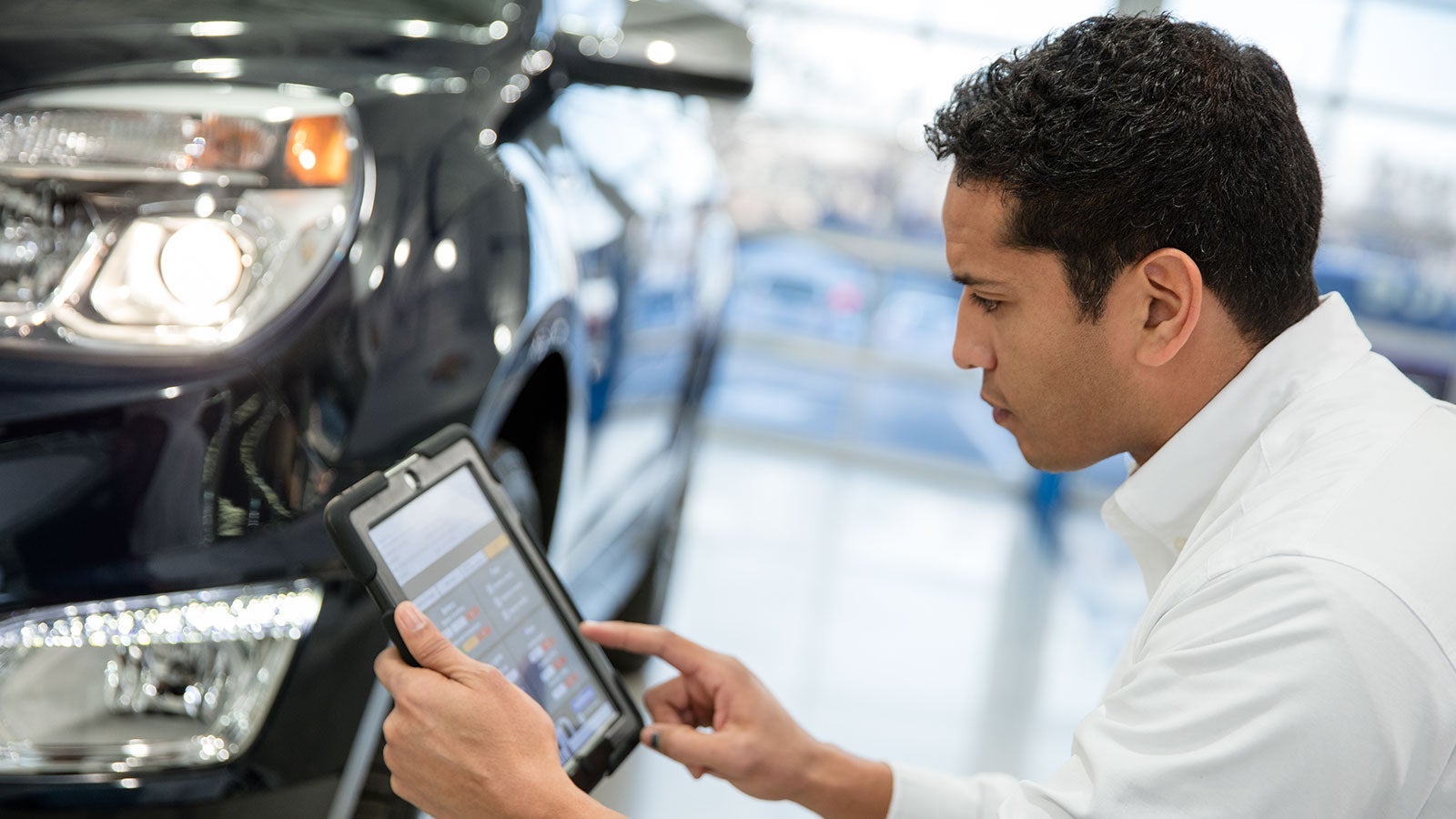 service advisor with tablet Turan-Foley Chevrolet in Gulfport MS